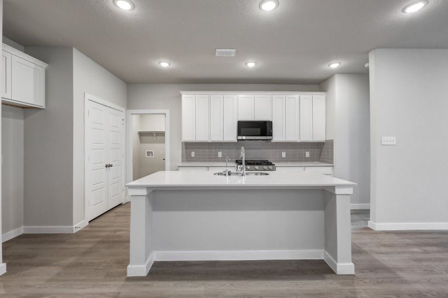 A kitchen with white cabinets. A kitchen with white cabinets.