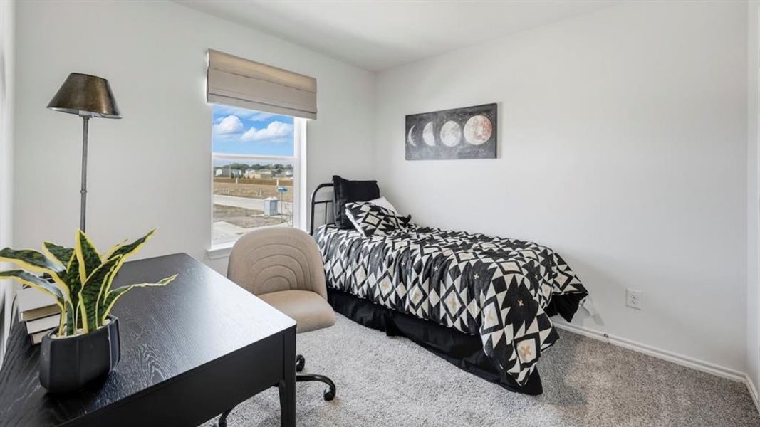 Carpeted bedroom featuring baseboards