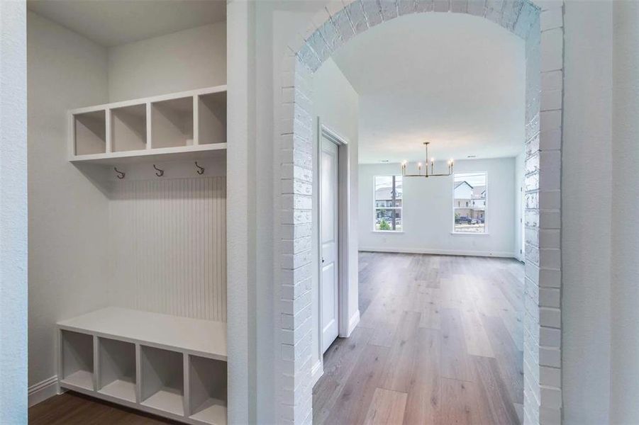 Mudroom featuring a chandelier and wood finished floors Mudroom featuring a chandelier and wood finished floors