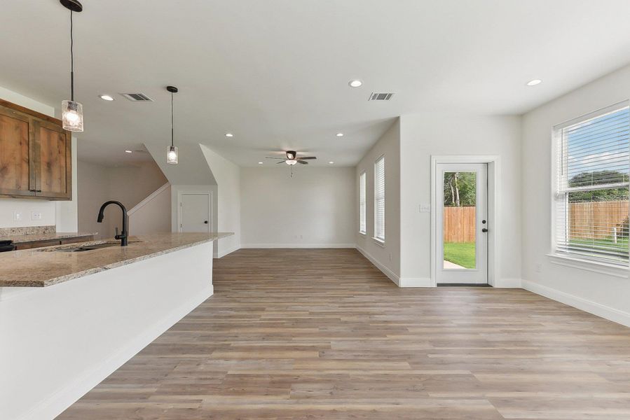 Kitchen / Dining / Living room featuring light wood-type flooring, visible vents, a sink, and recessed lighting