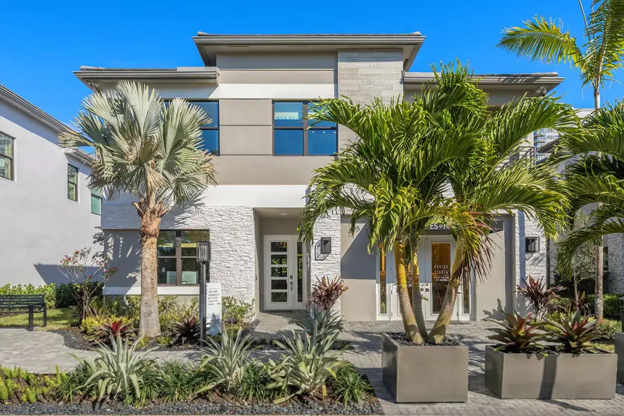 Front exterior of a new home in The Estates @ NOMAR, West Palm Beach, FL, highlighting curb appeal (Image 1). Front exterior of a new home in The Estates @ NOMAR, West Palm Beach, FL, highlighting curb appeal (Image 1).