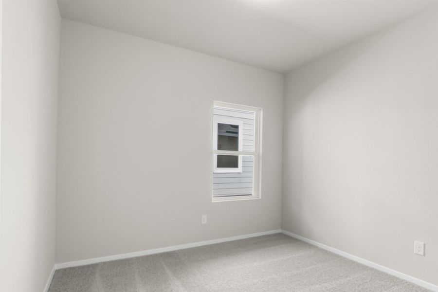 Image of a bedroom with cream walls, tan walls, white trim and a window