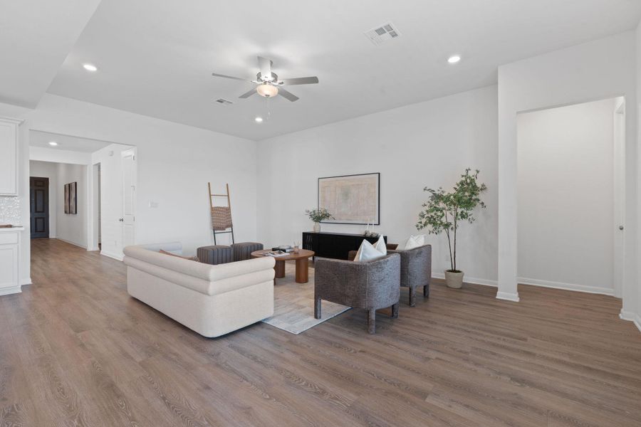 Living area with a ceiling fan, wood finished floors, recessed lighting, and baseboards