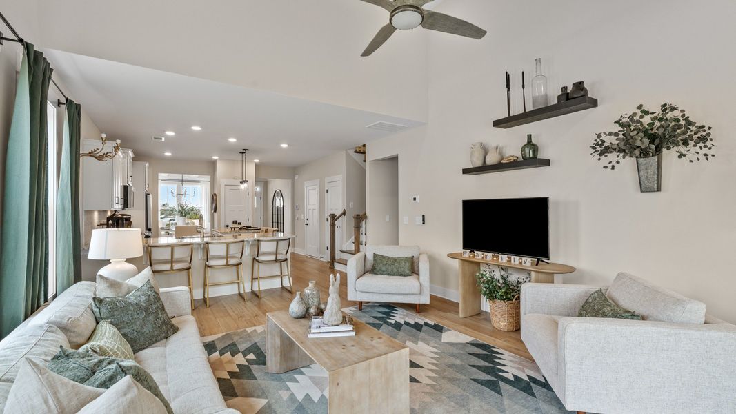 Exceptional family space featuring two-story ceilings, hardwood flooring, and tasteful finishes throughout at Barton Hollow