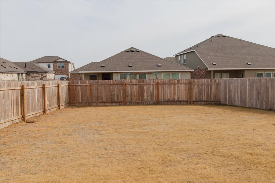 Expansive backyard offering endless possibilities: plant a garden, build a pool, or unwind on the covered patio while taking in the view.