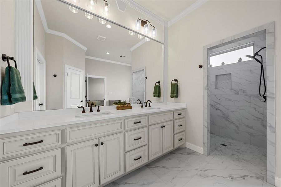 Spacious primary bathroom with dual vanity, white cabinetry, and walk-in shower with bench seating. Spacious primary bathroom with dual vanity, white cabinetry, and walk-in shower with bench seating.