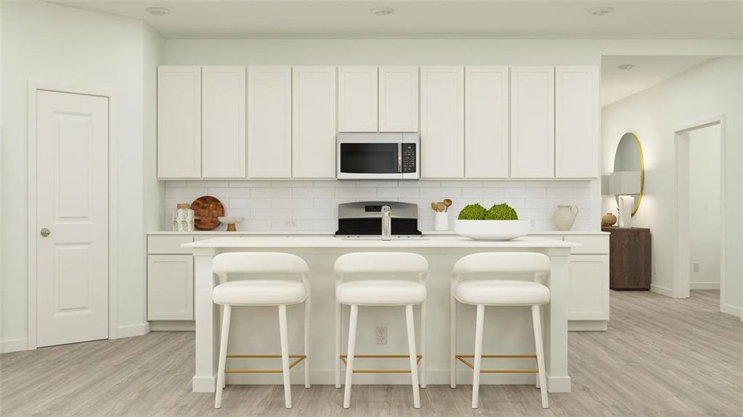 Kitchen with backsplash, white cabinetry, range, and light wood-type flooring