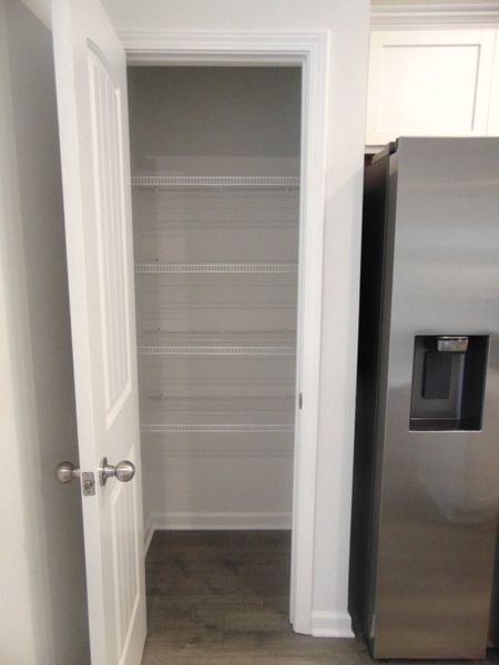 The kitchen is spacious and modern, it comes with steel appliances, and crown cabinetry for a unique look