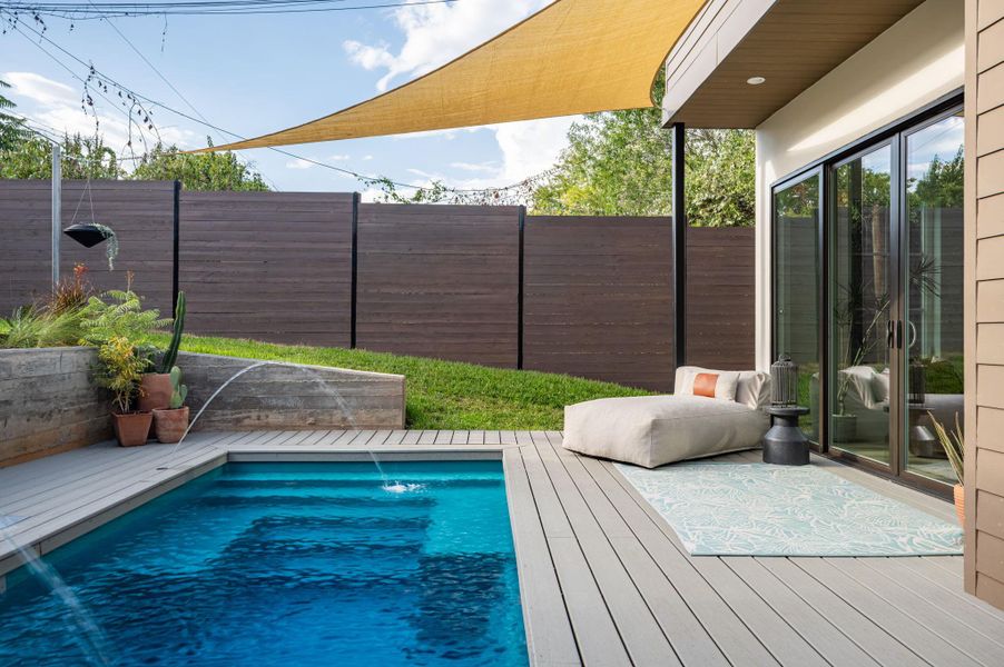 An inviting backyard oasis features a modern plunge pool alongside composite decking and privacy fencing. An inviting backyard oasis features a modern plunge pool alongside composite decking and privacy fencing.