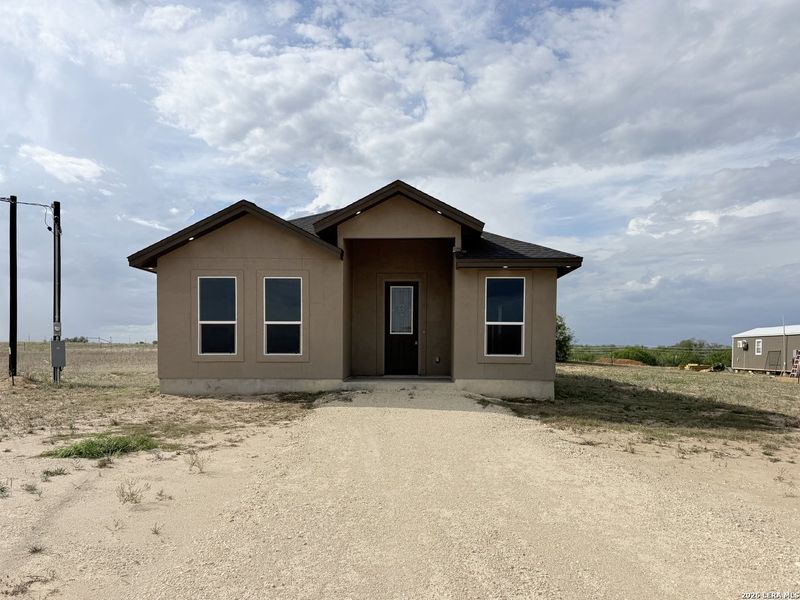 Front exterior of a new home in , La Vernia, TX, highlighting curb appeal (Image 1). Front exterior of a new home in , La Vernia, TX, highlighting curb appeal (Image 1).