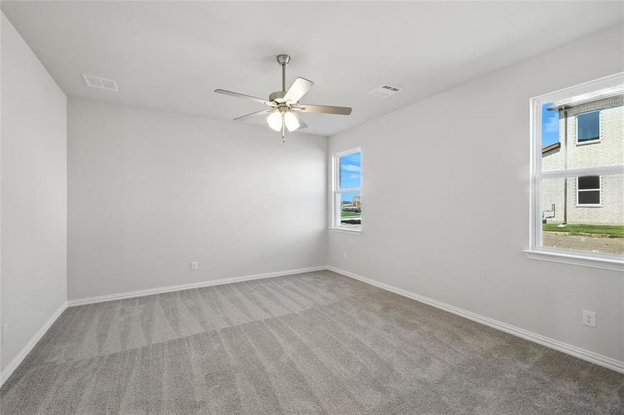 Spare room with carpet floors and ceiling fan Spare room with carpet floors and ceiling fan