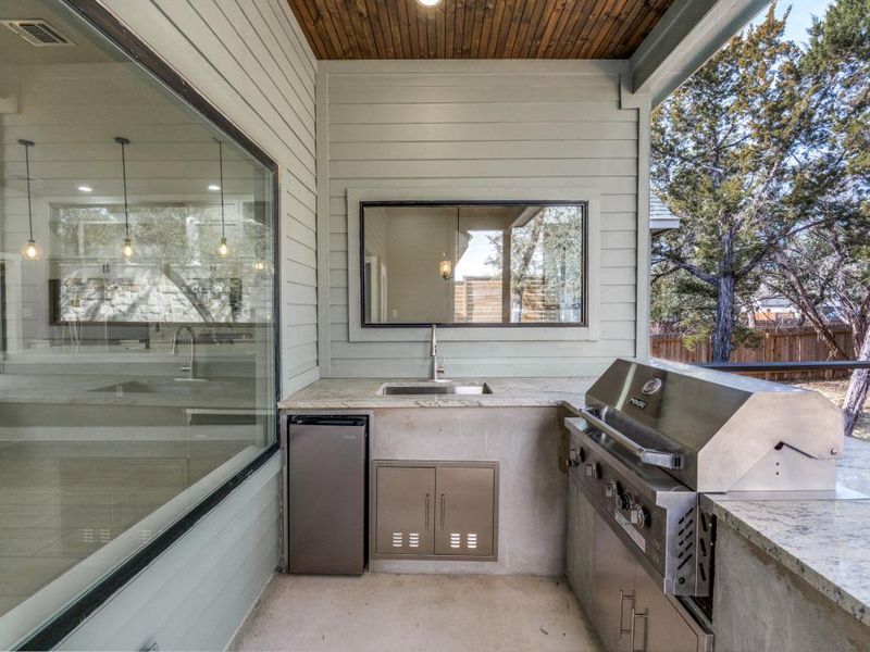 View of patio featuring an outdoor kitchen and a sink