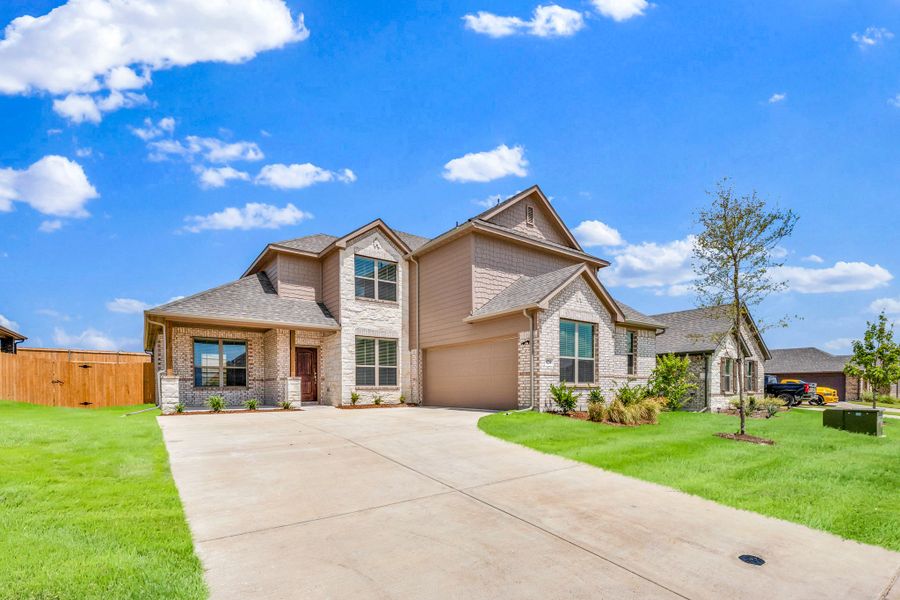 Front exterior of a new home in Summerwood, Red Oak, TX, highlighting curb appeal (Image 24). Front exterior of a new home in Summerwood, Red Oak, TX, highlighting curb appeal (Image 24).