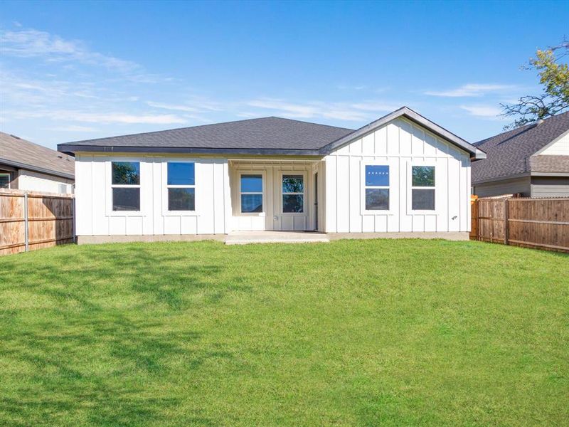 Rear view of property featuring a patio area and a yard