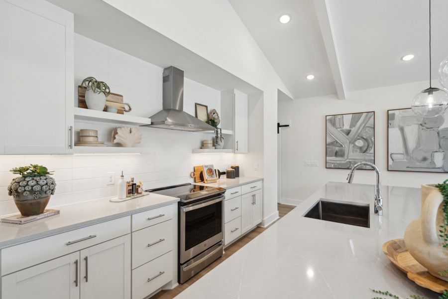 Kitchen with stainless steel vent hood