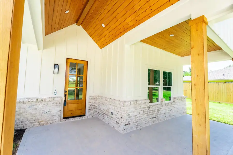 Modern exterior featuring premium siding & beautiful brick accents, creating timeless curb appeal with a warm modern farmhouse design