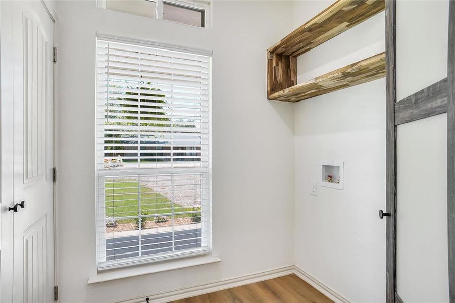 Laundry area with hardwood / wood-style flooring and hookup for a washing machine