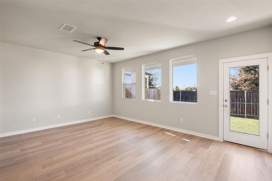 Unfurnished room with light wood-type flooring and a ceiling fan Unfurnished room with light wood-type flooring and a ceiling fan
