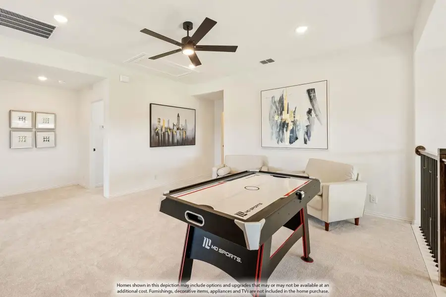 Game room with air hockey table, ceiling fan, carpet flooring, and neutral walls with framed artwork