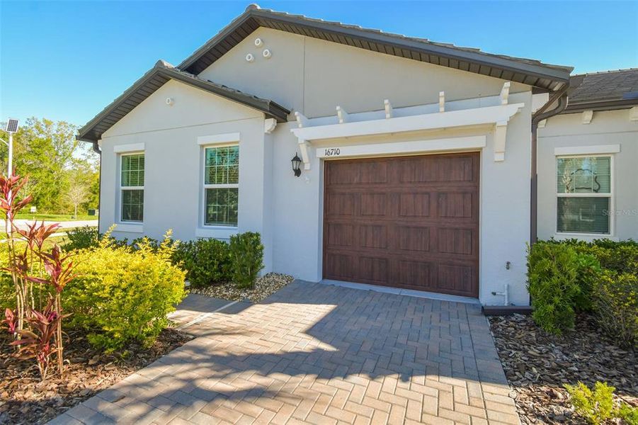 Front exterior of a new home in Angeline Active Adult, Land O' Lakes, FL, highlighting curb appeal (Image 20).