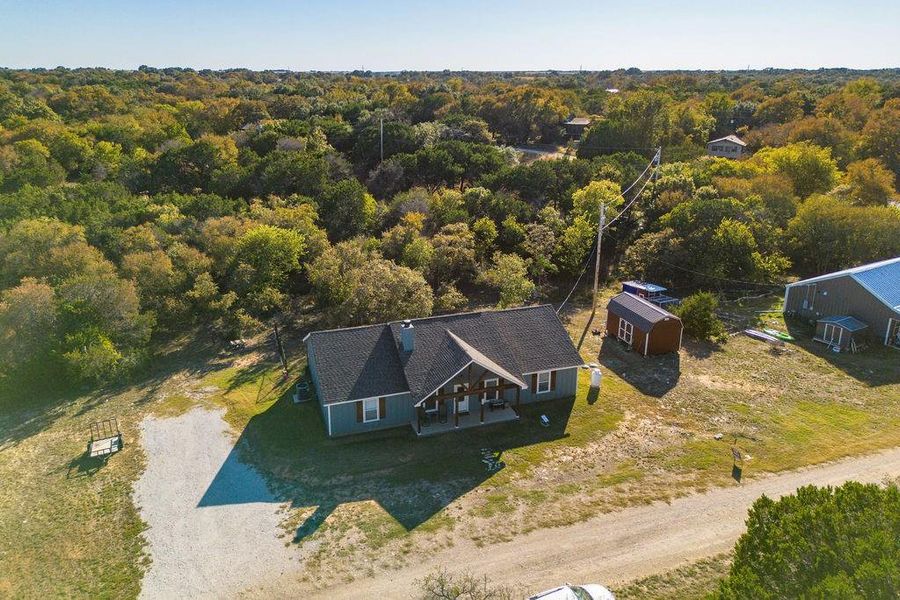 View from above of property featuring a heavily wooded area