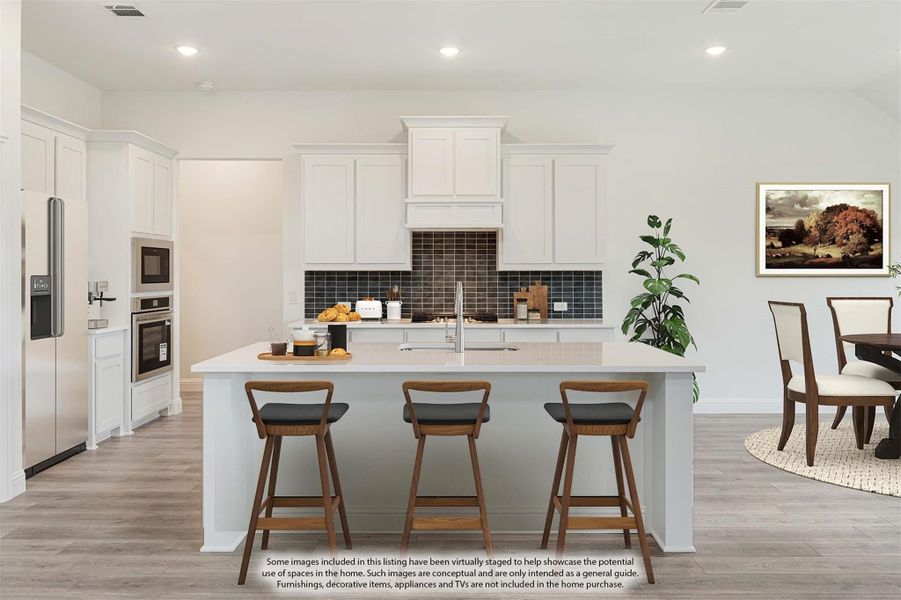 White kitchen with large island, three bar stools, dark tile backsplash, and stainless steel appliances White kitchen with large island, three bar stools, dark tile backsplash, and stainless steel appliances