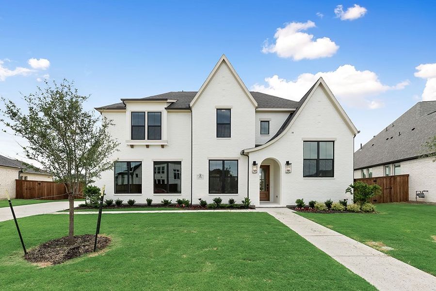 Front exterior of a new home in Light Farms Graham/Reagan, Celina, TX, highlighting curb appeal (Image 24). Front exterior of a new home in Light Farms Graham/Reagan, Celina, TX, highlighting curb appeal (Image 24).