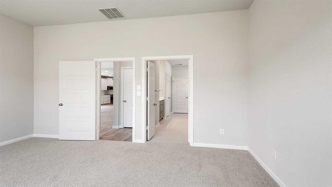 Unfurnished bedroom featuring light colored carpet