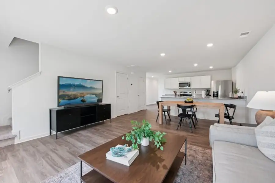 A living room with a tv and a table.