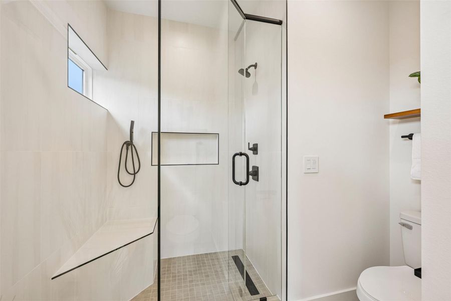 A sleek, contemporary shower with a window above, perfect for a refreshing start or relaxing finish to your day.