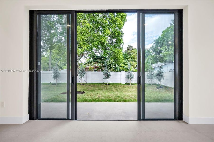 Living Room has w-i-i-i-i-de impact glass silders to patio and backyard Living Room has w-i-i-i-i-de impact glass silders to patio and backyard