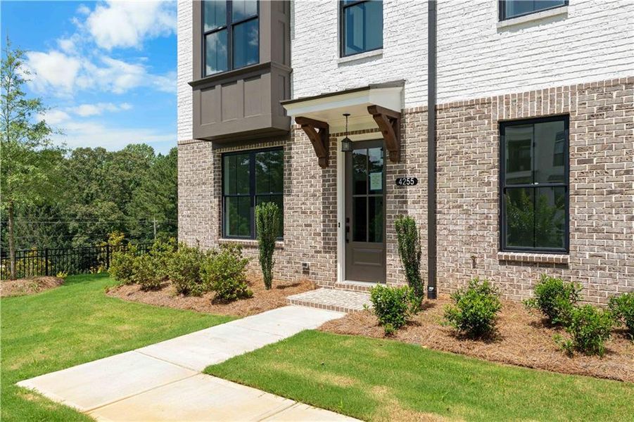 Exterior details and patio area of a home in Millcroft Townhomes, Buford (Image 21).