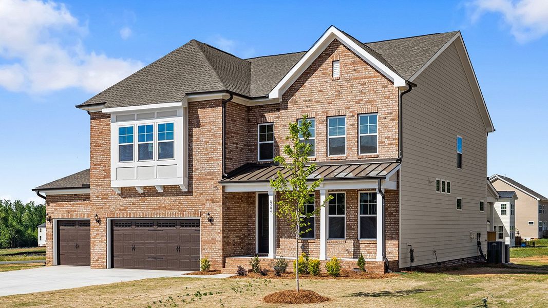 Front exterior of a new home in Lilah Grove, Summerfield, NC, highlighting curb appeal (Image 22).