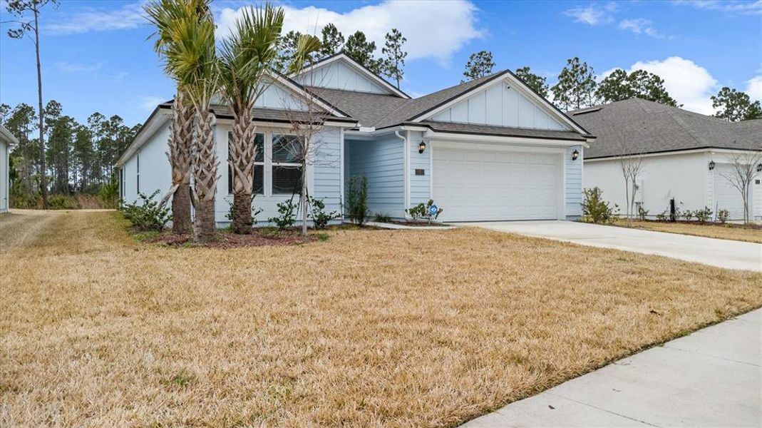 Front exterior of a new home in Sawmill Branch, Palm Coast, FL, highlighting curb appeal (Image 2). Front exterior of a new home in Sawmill Branch, Palm Coast, FL, highlighting curb appeal (Image 2).