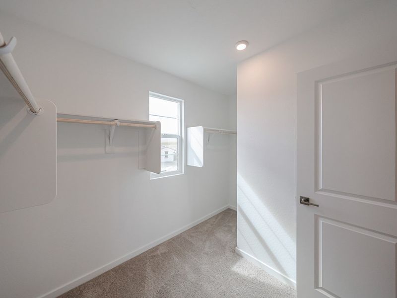 A room with white walls and a window.