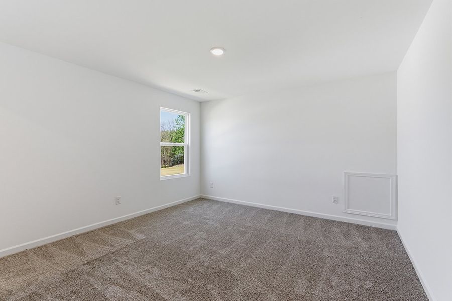 A room with a window and a carpet. A room with a window and a carpet.