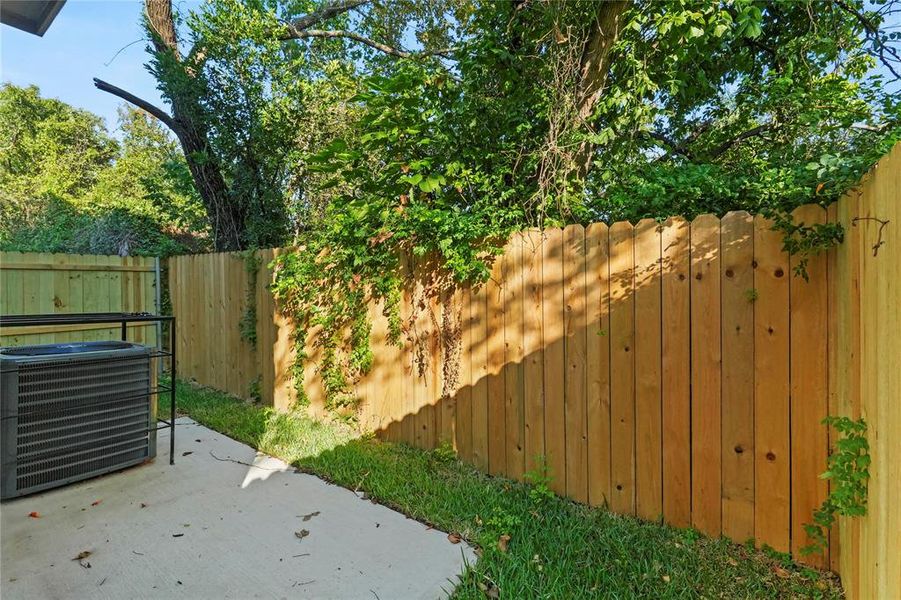 Fenced backyard featuring a patio