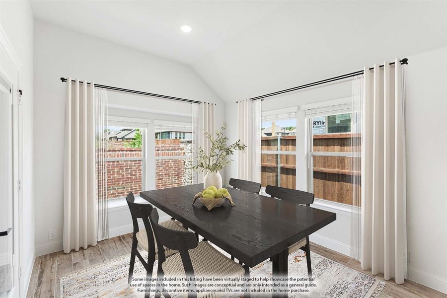 Dining room with dark wood table, four chairs, vaulted ceiling, and large windows with white curtains