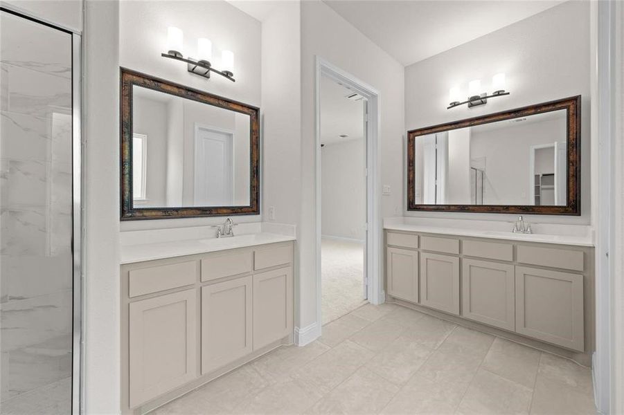 Bathroom featuring tile patterned floors, a shower, and vanity