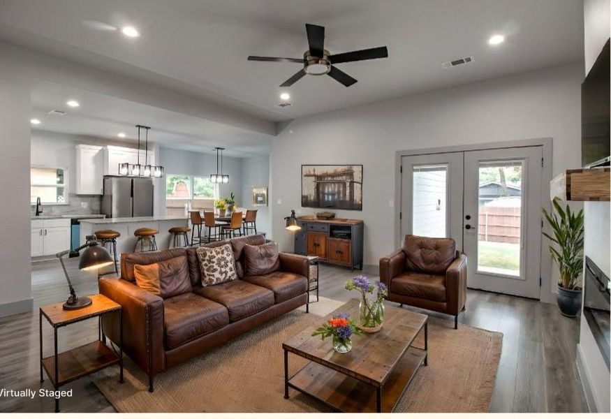 Living area featuring wood finished floors, ceiling fan, recessed lighting, and french doors Living area featuring wood finished floors, ceiling fan, recessed lighting, and french doors