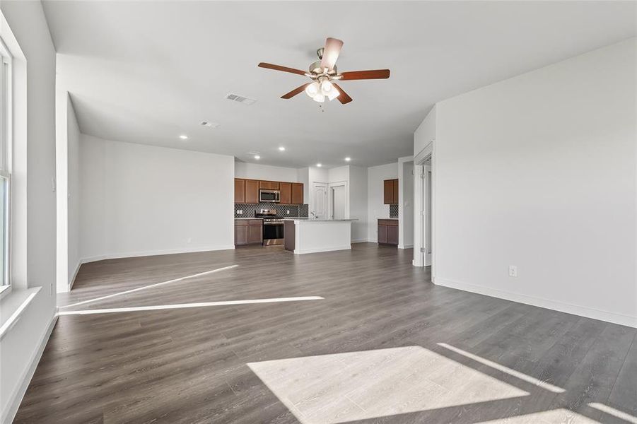 Unfurnished living room with recessed lighting, dark wood-type flooring, and ceiling fan Unfurnished living room with recessed lighting, dark wood-type flooring, and ceiling fan
