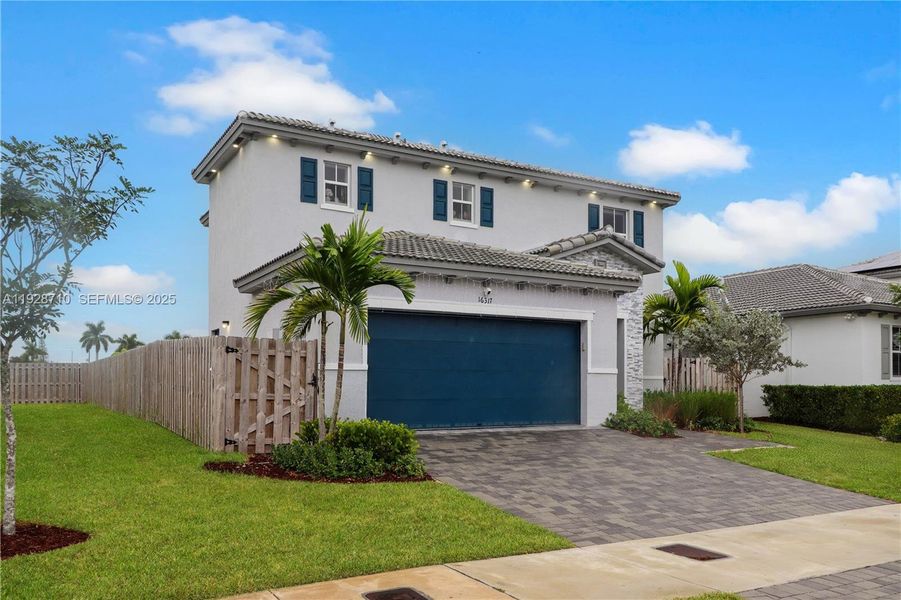 Front exterior of a new home in , Homestead, FL, highlighting curb appeal (Image 2). Front exterior of a new home in , Homestead, FL, highlighting curb appeal (Image 2).