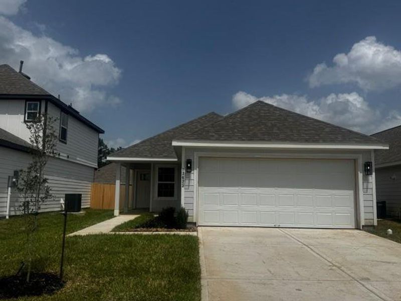 Front exterior of a new home in Townsend Reserve, Splendora, TX, highlighting curb appeal (Image 1). Front exterior of a new home in Townsend Reserve, Splendora, TX, highlighting curb appeal (Image 1).