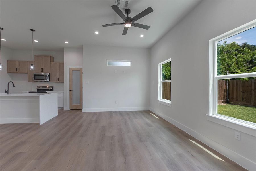 Expansive windows fill the home with natural light, while the no-carpet design and lovely fixtures add a clean, elevated feel throughout. Expansive windows fill the home with natural light, while the no-carpet design and lovely fixtures add a clean, elevated feel throughout.