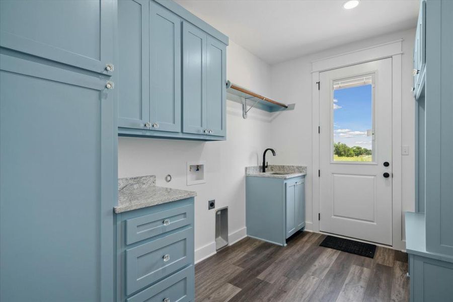 Washroom featuring electric dryer hookup, washer hookup, cabinet space, dark wood-type flooring, and recessed lighting