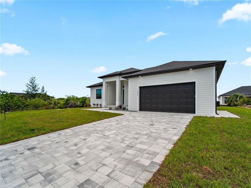 Front exterior of a new home in , Port Charlotte, FL, highlighting curb appeal (Image 2). Front exterior of a new home in , Port Charlotte, FL, highlighting curb appeal (Image 2).