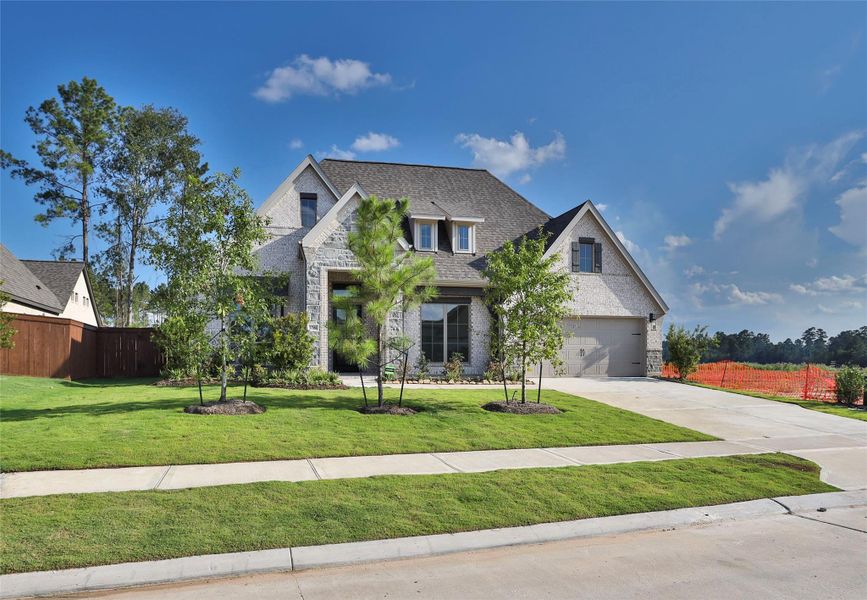 Front exterior of a new home in Evergreen 70', Conroe, TX, highlighting curb appeal (Image 1). Front exterior of a new home in Evergreen 70', Conroe, TX, highlighting curb appeal (Image 1).