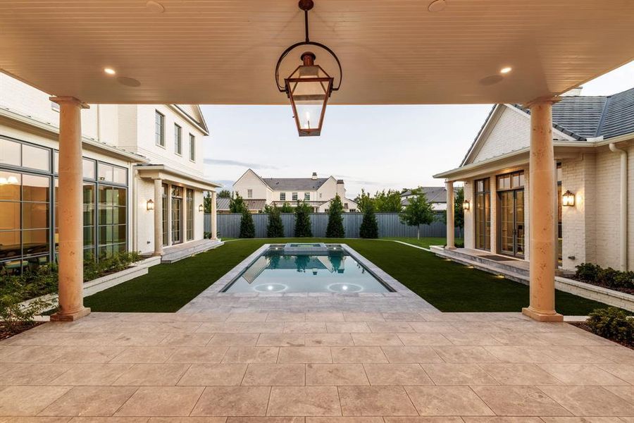 View of pool featuring a patio area, a fenced backyard, a swimming pool, and an in-ground hot tub View of pool featuring a patio area, a fenced backyard, a swimming pool, and an in-ground hot tub