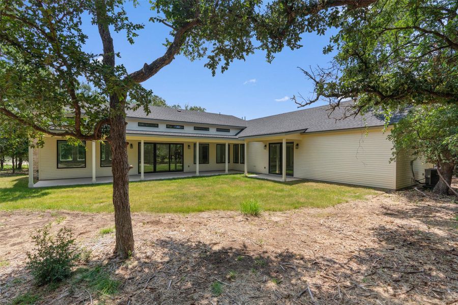 A spacious backyard with an inviting covered patio, ideal for outdoor gatherings and relaxation.