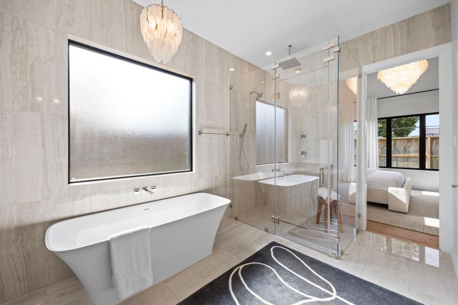 Primary Bath includes a soak tub w/ privacy window & walk-in shower. Gorgeous tile from floor to ceiling on the walls.